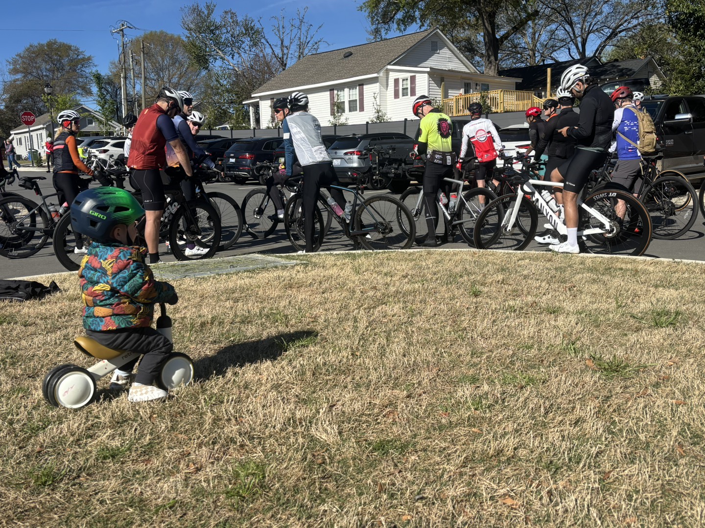 Small cyclist with large cyclists at spring rally